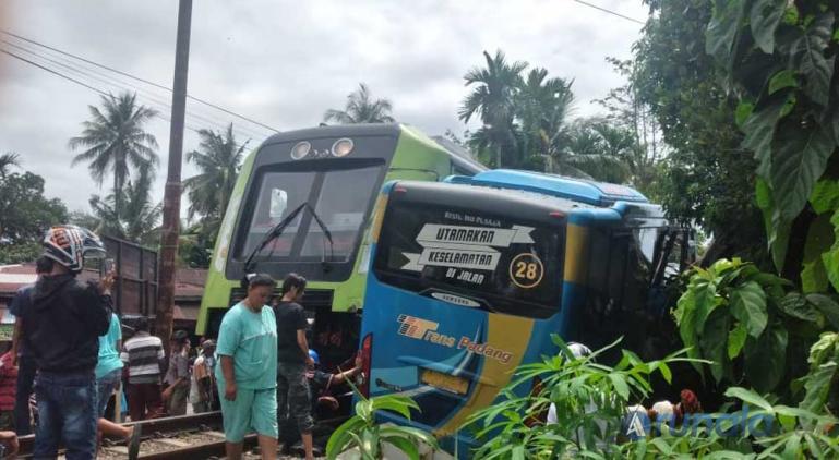 Terlihat KA Minangkabau Express dengam Bus Trans Padang di pelintasan KA Simpang Anak Air, Keluarahan Batipuah Panjang Kecamatan Koto Tangah Koto Padang, Rabu (13/1). (Foto : Can)