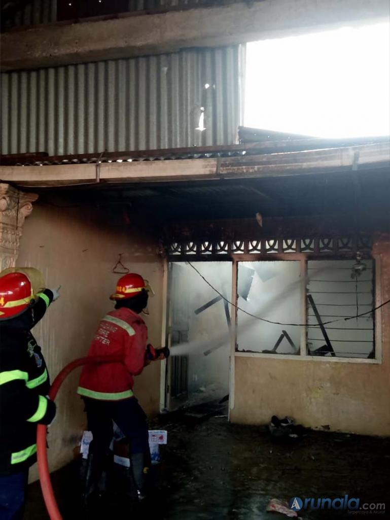 Petugas Damkar Kota Padang sedang berusaha memadamkan api yang membakar rumah warga di kawasan Balai Baru, Senin siang (15/2). (Foto : Can)