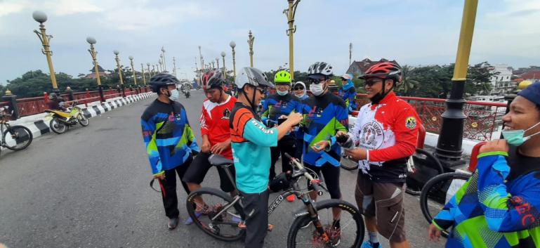 Asisten Deputi III Bidang Pembudayaan Olahraga Kemenpora RI, Maifrizon, bersama jajaran Dispora Sumbar, dan Kota Padang serta Dispora bagikan masker pada warga yang sedang olahraga sepeda di Padang, Selasa (16/2). (Dok : Istimewa)