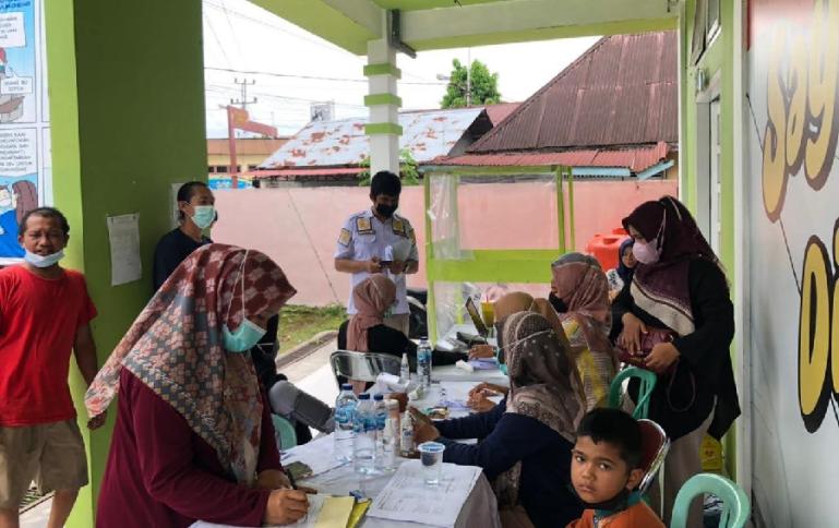 BKO Ditresnarkoba Polda Sumbar, Bripka Jimmy Rahmadani berkoordinasi dengan vaksinator Puskesmas Pasar Baru, Bayang, Sabtu (12/11). (Dok : Istimewa)