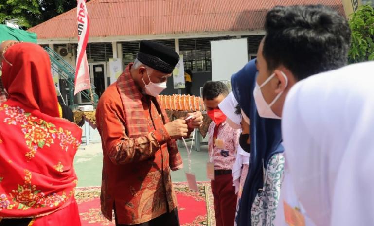 Gubernur Sumbar, Mahyeldi memasangkan tanda peserta kompetisi Tensailicious 2022 se Sumatera di SMAN 10 Padang, Kamis (24/2). (Dok : Istimewa)