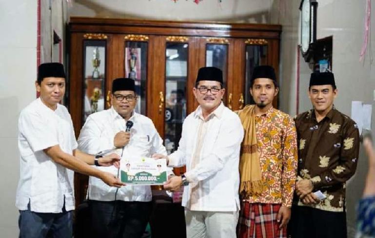 Bupati Padangpariaman, Suhatri Bur serahkan bantuan pada pengurus Surau Duri Nagari Bisati saat kunjungan Safari Ramadan, Kamis malam (6/4). (Dok : Istimewa)