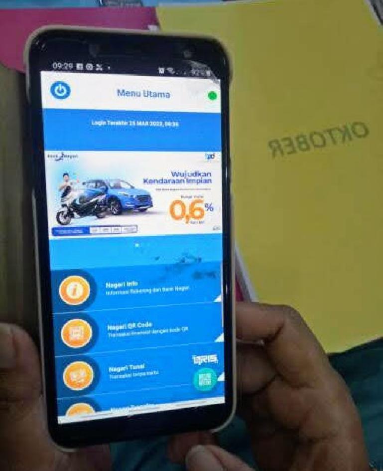 Nasabah Bank Nagari memperlihatkan Nagari Mobile Banking. (Dok : Istimewa)