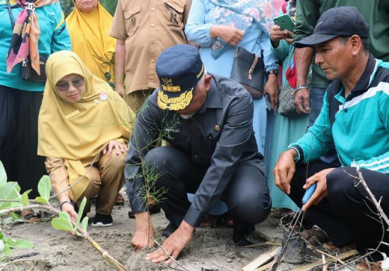 Gubernur Sumbar, Mahyeldi bersama Kadis Kelautan dan Perikanan Sumbar Desniarti secara simbolis melakukan penanaman bibit 1.400 bibit pohon laut cemara di Pantai Nagari Nyiur Melambai, Kampung Sumedang, Kabupaten Pesisir Selatan, Selasa (4/10). (Dok : Ist