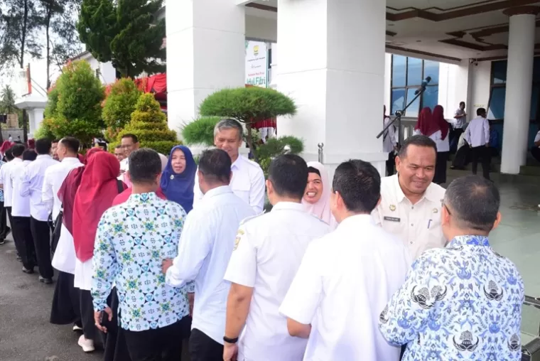 Para ASN dan non ASN di Pemko Pariaman bersalaman dengan Pj Wali Kota Roberia dan Sekko Yota Balad seusai apel gabungan, Rabu pagi (17/4/2024). (Dok : Kominfo Kota Pariaman)
