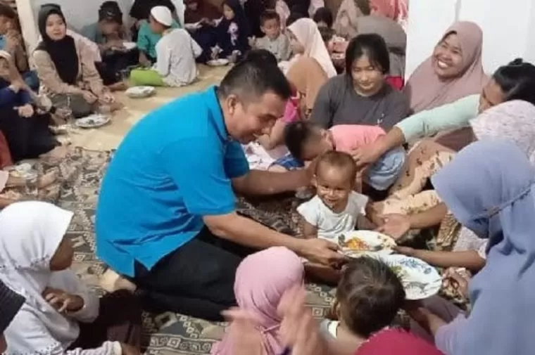 Camat Lubeg, Nofiandi Amir menyuapkan asupan gizi pada sejumlah balita saat pelaksanaan BAS Dagozi di Kelurahan Banuaran Nan XX, Jumat (23/5/2024) lalu. (dok : istimewa)