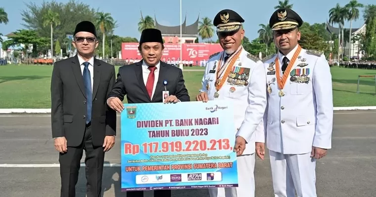 Direktur Utama Bank Nagari Gusti Candra menyerahkan dividen tahun buku 2023 ke Gubernur Sumbar Mahyeldi Ansharullah didampingi Wagub Sumbar Audy Joinaldy usai Peringatan HUT ke-79 RI di Istana Gubernuran, Sabtu (17/8/2024). Humas Bank Nagari
