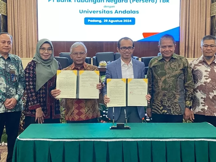 Rektor Unand Efa Yonnedi PhD dan Direktur Distribution and Instutional Funding BTN Jasmin memperlihatkan nota kesepahaman di Convention Hall Unand, Kamis (29/8/2024). IST