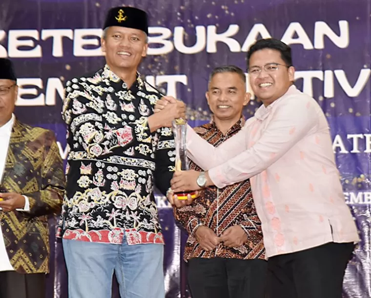 PJ wali Kota Pariaman, Roberia saat menerima penghargaan predikat informatif dari KI Sumbar. IST