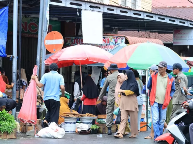 Anggota dari Sal Pol PP Kota Pariaman mengatur para pedagang yang ada di kawasan Pasar Rakyat Pariaman saat operasi penertiban, Kamis pagi (27/2/2025). IST