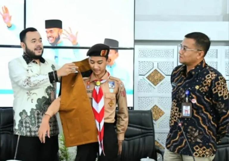 Wali Kota Padang, Fadly Amran secara simboles memasangkan rompi kepada salah seorang anggota Pramuka Kota Padang yang akan ikut WMSJ di Bumi Perkemahan Cibubur. IST