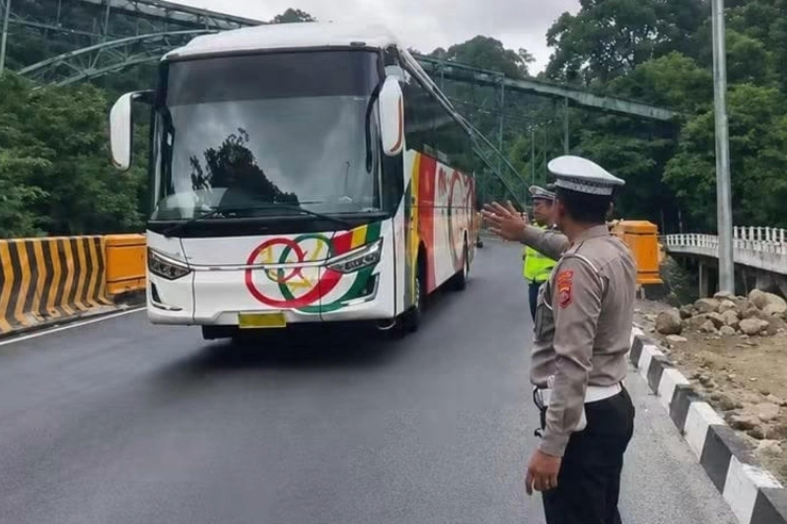 Petugas Lantas sedang mengatur kendaraan bus yang melewati jalur Lembah Anai. Terhitung Senin (27/7/2026) ruas jalan Lembah Anai ini Kembali bisa dilewati berbagai jenis kendaraan. IST